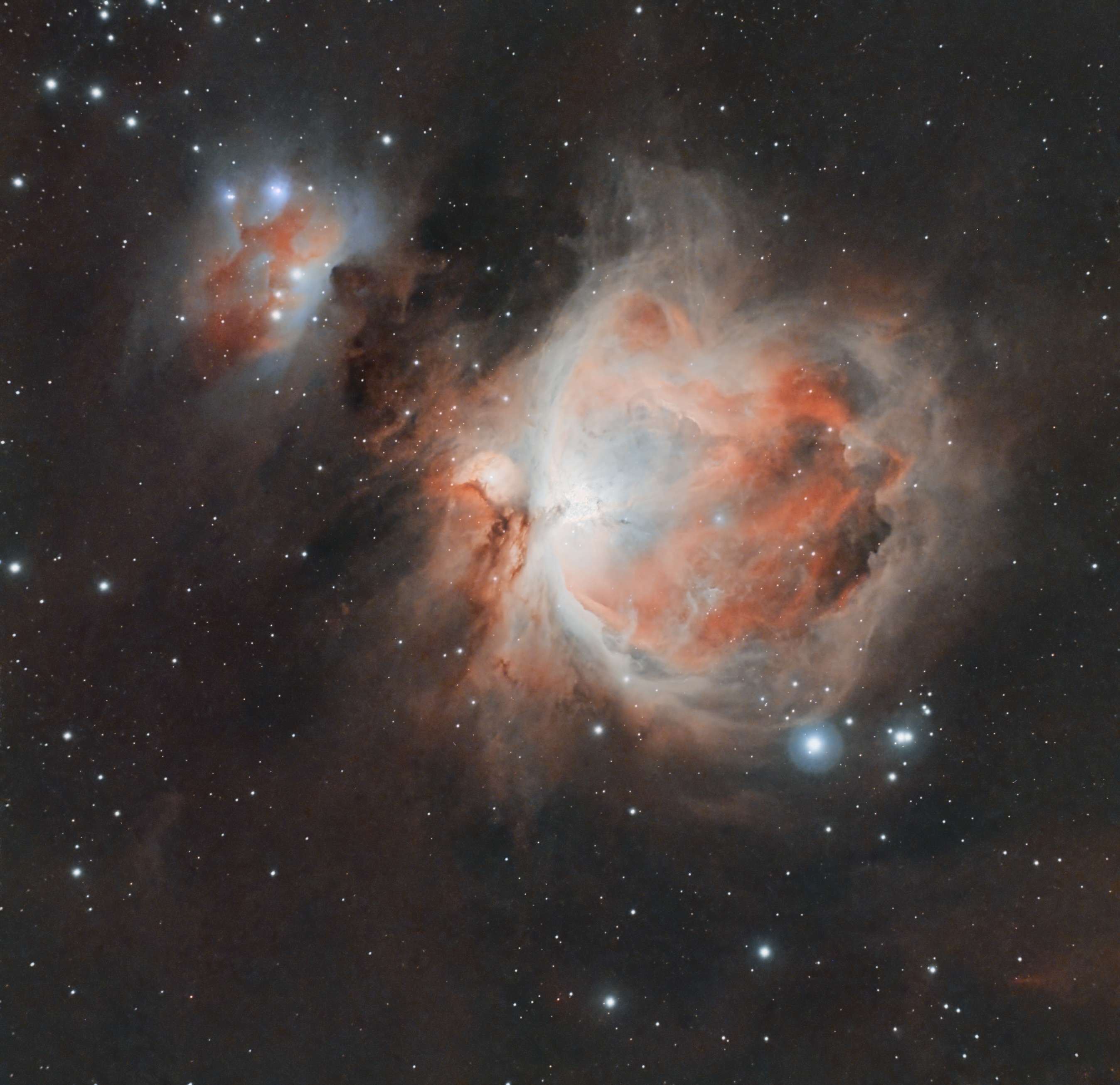 Close view of the Orion Nebula with orange and blue-gray dust