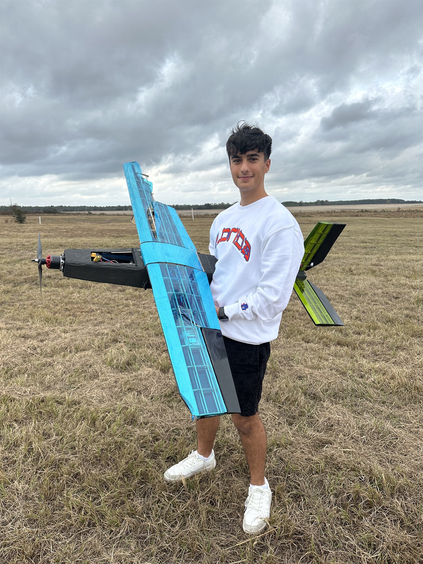 Ori holding Prototype 1 of a Design Build Fly aircraft